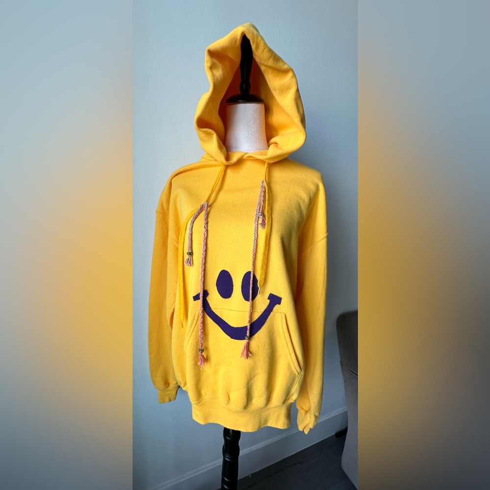 NWT “We Are One Project” Sunshine Yellow Hoodie with Purple Smiley Face in Large
